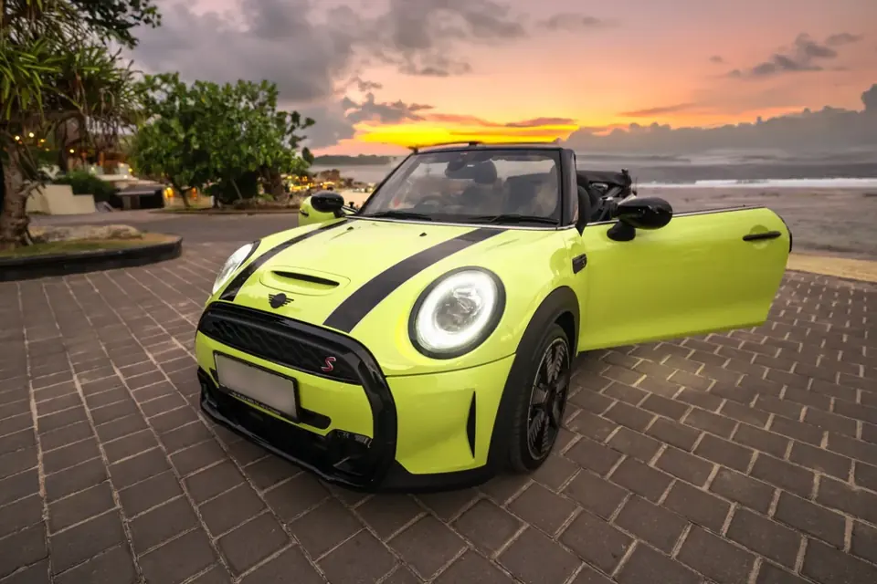 Yellow Mini Cooper S convertible by the sea
