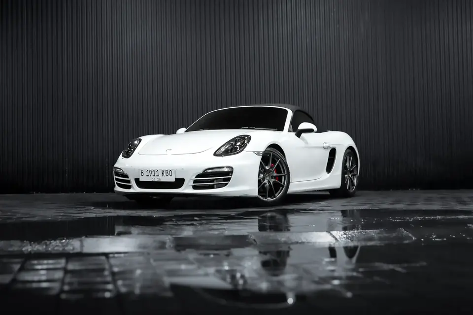 White Porsche Boxster 718 convertible in a studio