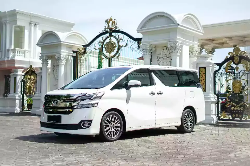 White Toyota Vellfire at a villa gate