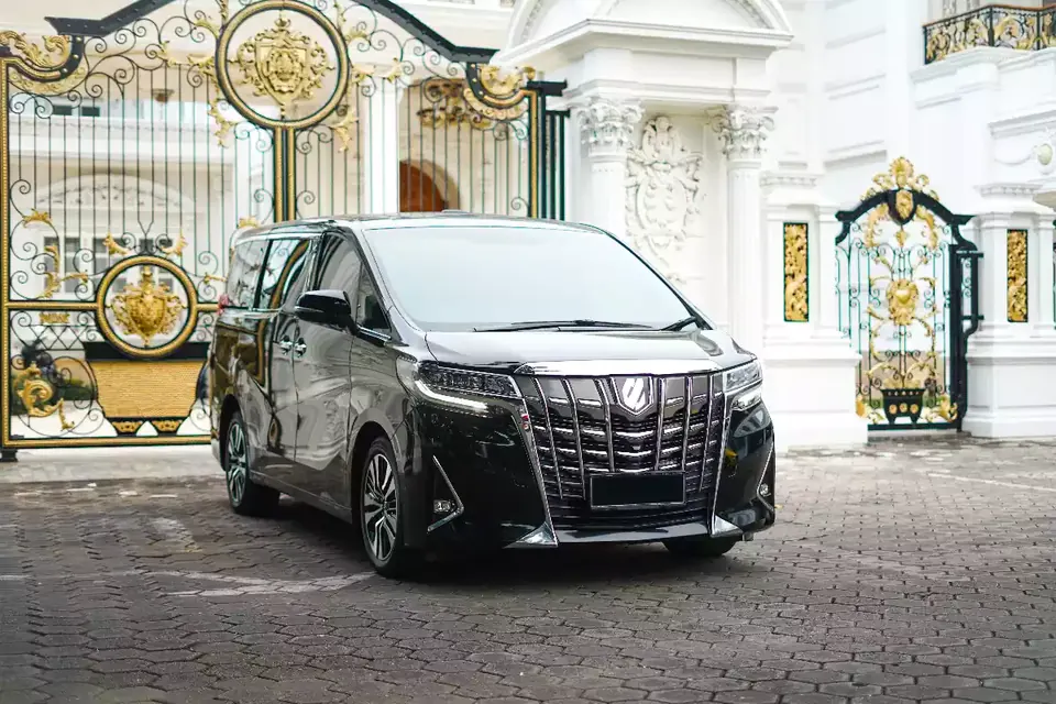 Black Toyota Alphard Facelift at a villa entrance in Bali