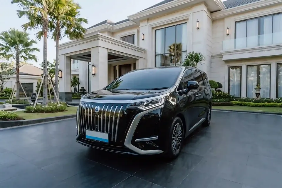 Black Denza D9 electric MPV outside a Bali villa